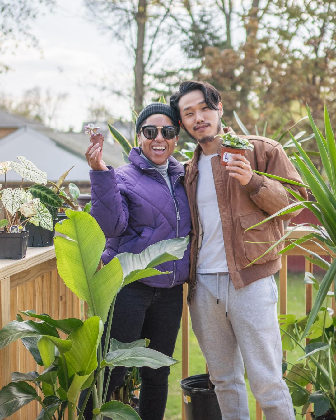 Maleea and Jae with plants on a porch